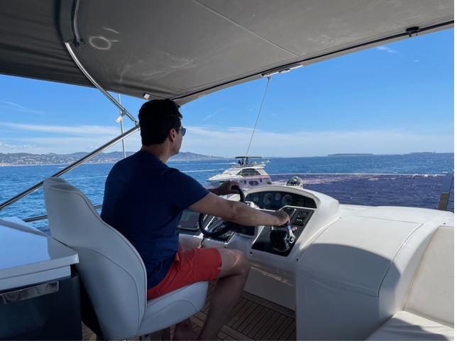 Pasquale at the flybridge helm of his motor yacht, underway on the Côte d'Azur