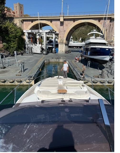 View from the helm of a motor yacht arriving at a Mediterranean boatyard travel lift